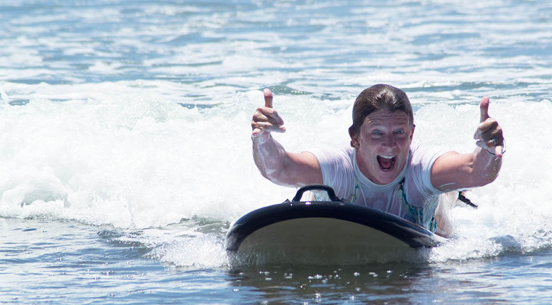 Surfer smiling and stoked in whitewater